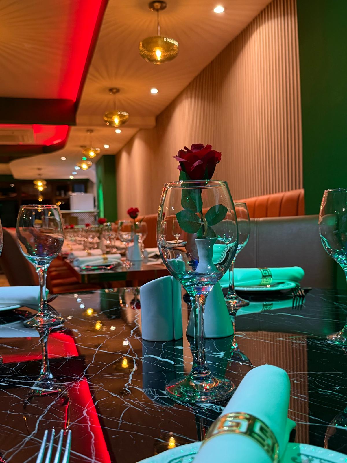 Dining room at Walton Spice with red chairs and table settings