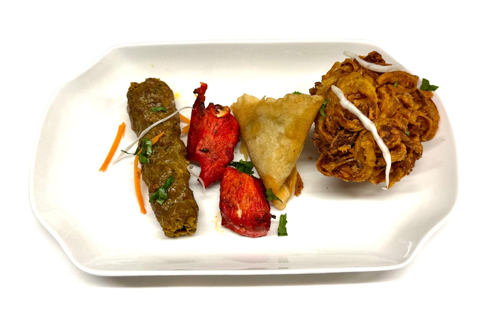 Tandoori chicken tikka garnished with herbs at Walton Spice