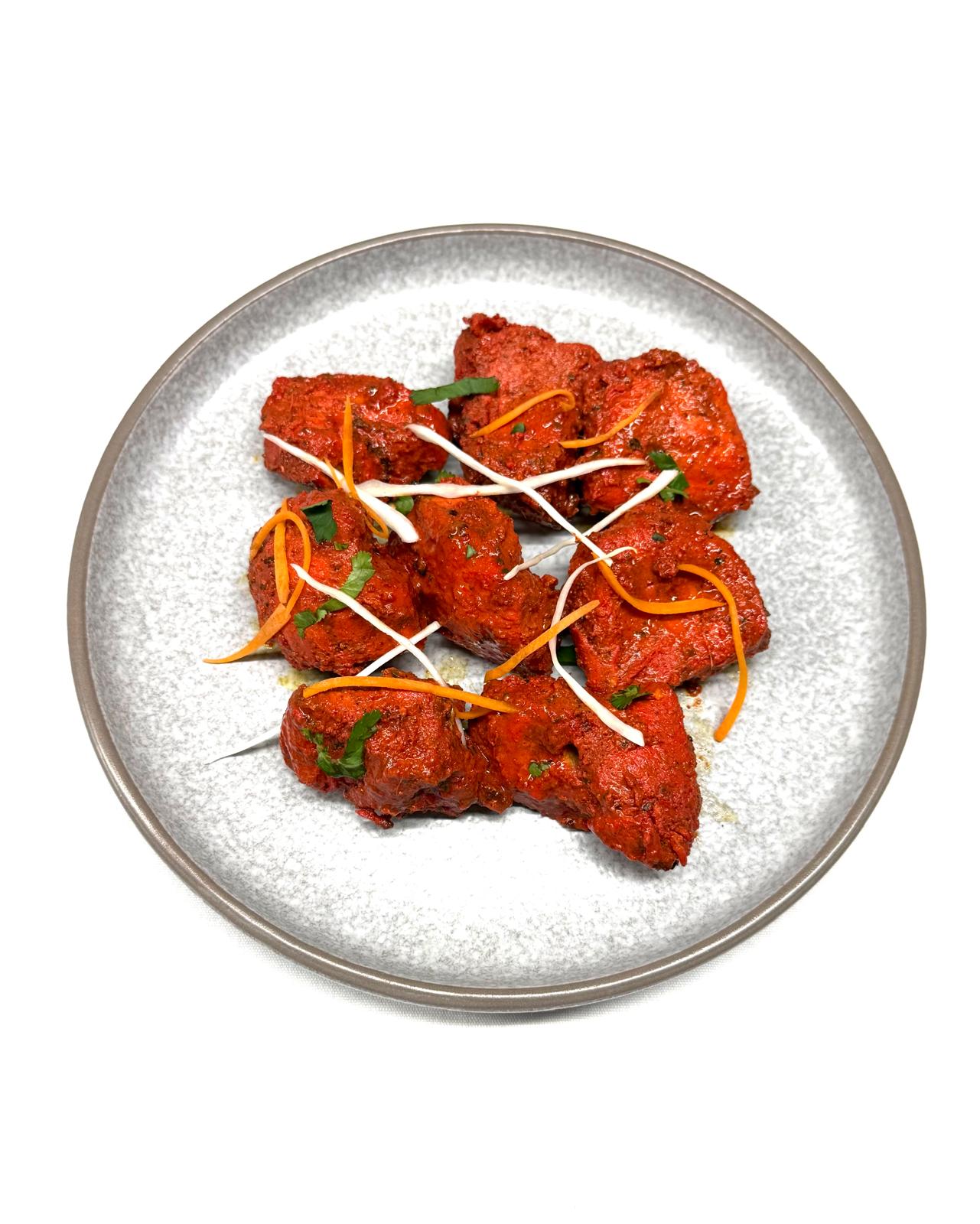 Chicken karahi with peppers and ginger served in a traditional pan