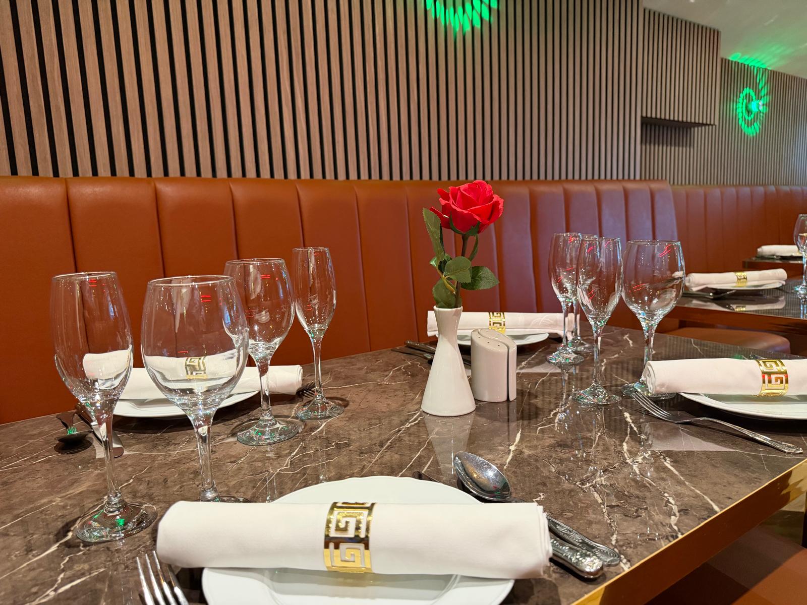 Dining room at Walton Spice with marble tables, leather seating and gold table settings